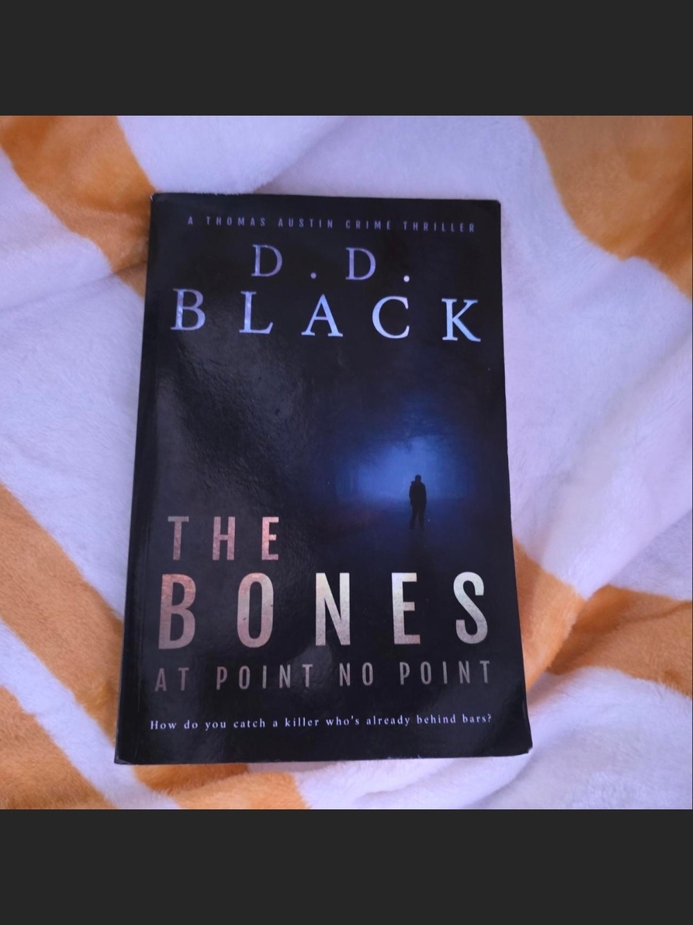The Bones Paperback Book - Black/Blue Cover